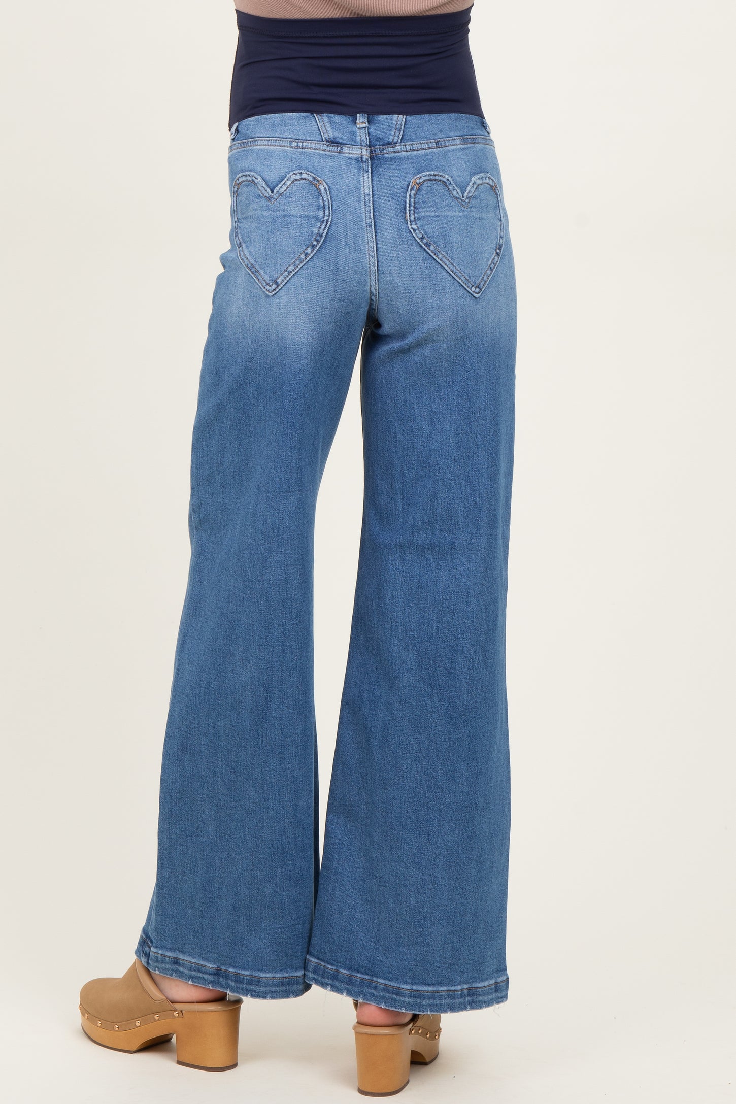 woman wearing light blue maternity wide-leg jeans with heart-shaped pockets on the back