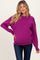 woman wearing a bright purple oversized maternity sweater with long sleeves and a visible baby bump