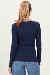 woman wearing a navy blue long sleeve maternity top with a fitted design and a gathered waist, shown from the back