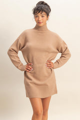 woman wearing a beige oversized turtleneck sweater dress with long sleeves and ribbed hem