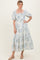 woman wearing a blue and white floral maxi dress with puff sleeves and a square neckline