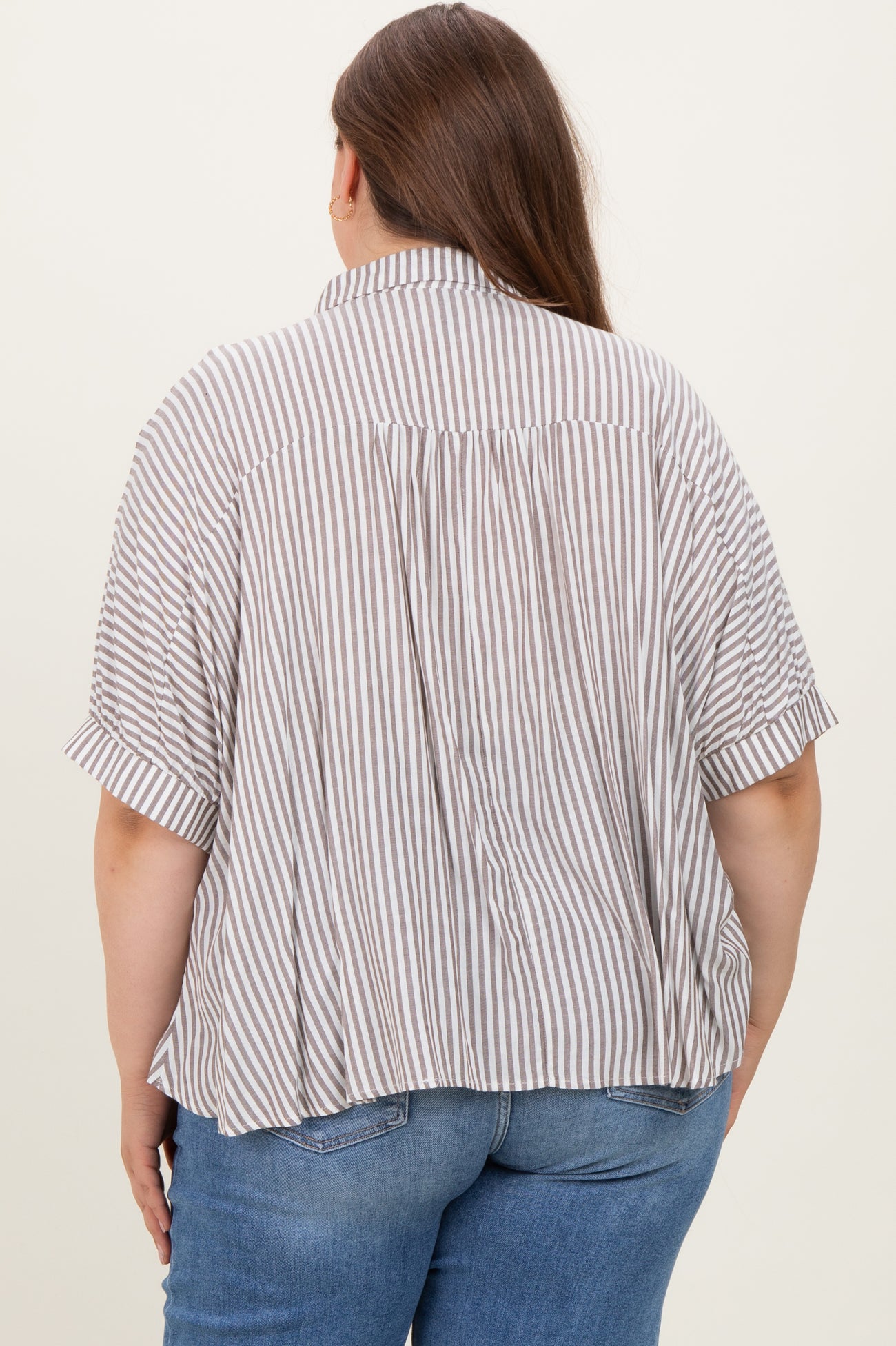 woman wearing a striped short sleeve maternity top, showing a loose fit and gathered back detail