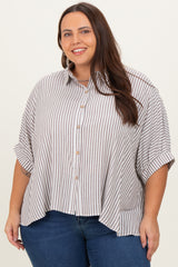 woman wearing a beige and white striped plus size button-up shirt with rolled sleeves and high-low hem