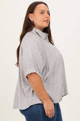 woman wearing a brown and white striped plus size shirt with a collar and short sleeves, standing sideways