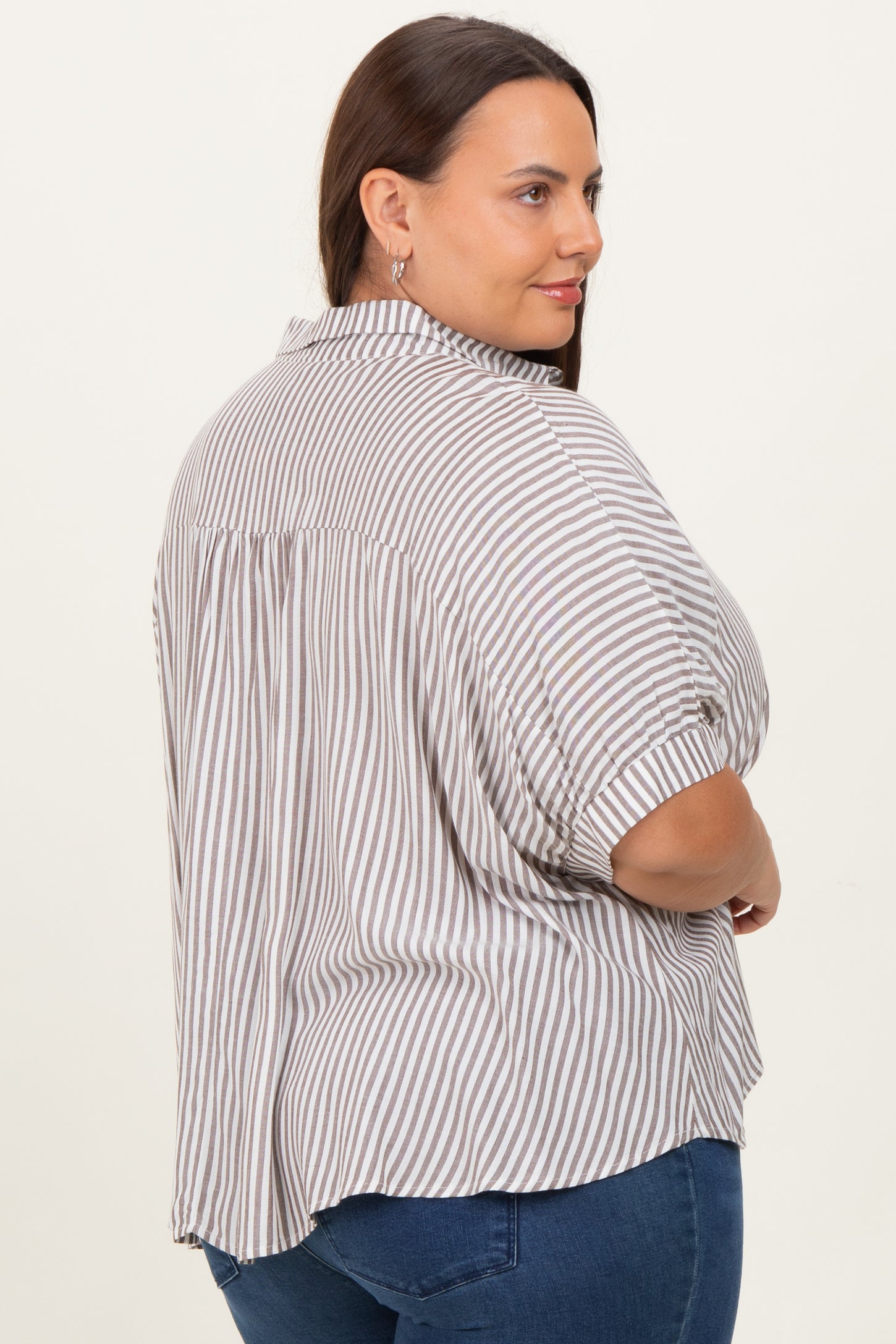 woman wearing a striped short sleeve plus size shirt with a button-down collar and a relaxed fit