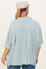 woman wearing a green and white striped maternity plus shirt, featuring a relaxed fit and roll-up sleeves