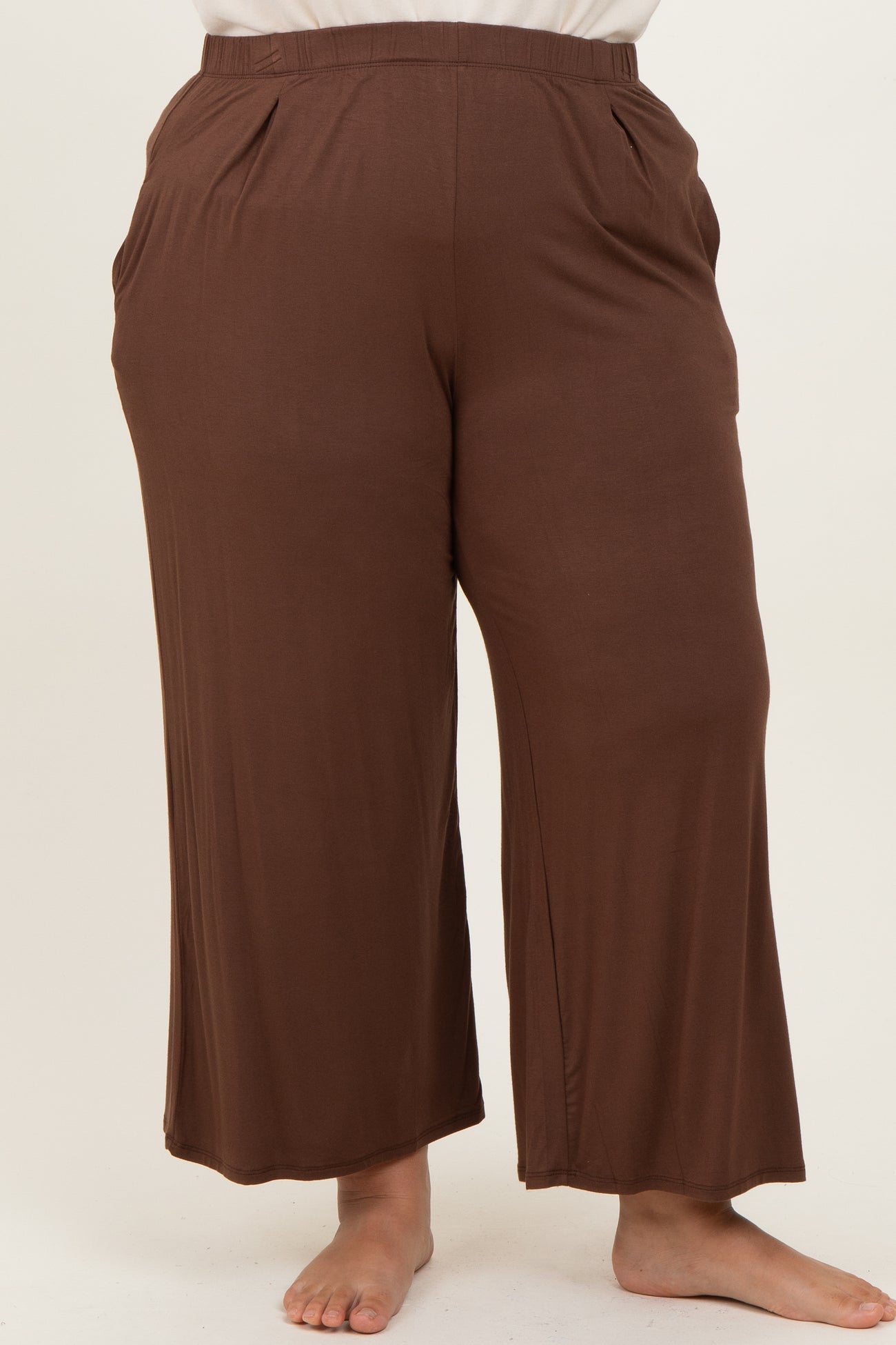 woman wearing brown plus size wide-leg pants with pockets