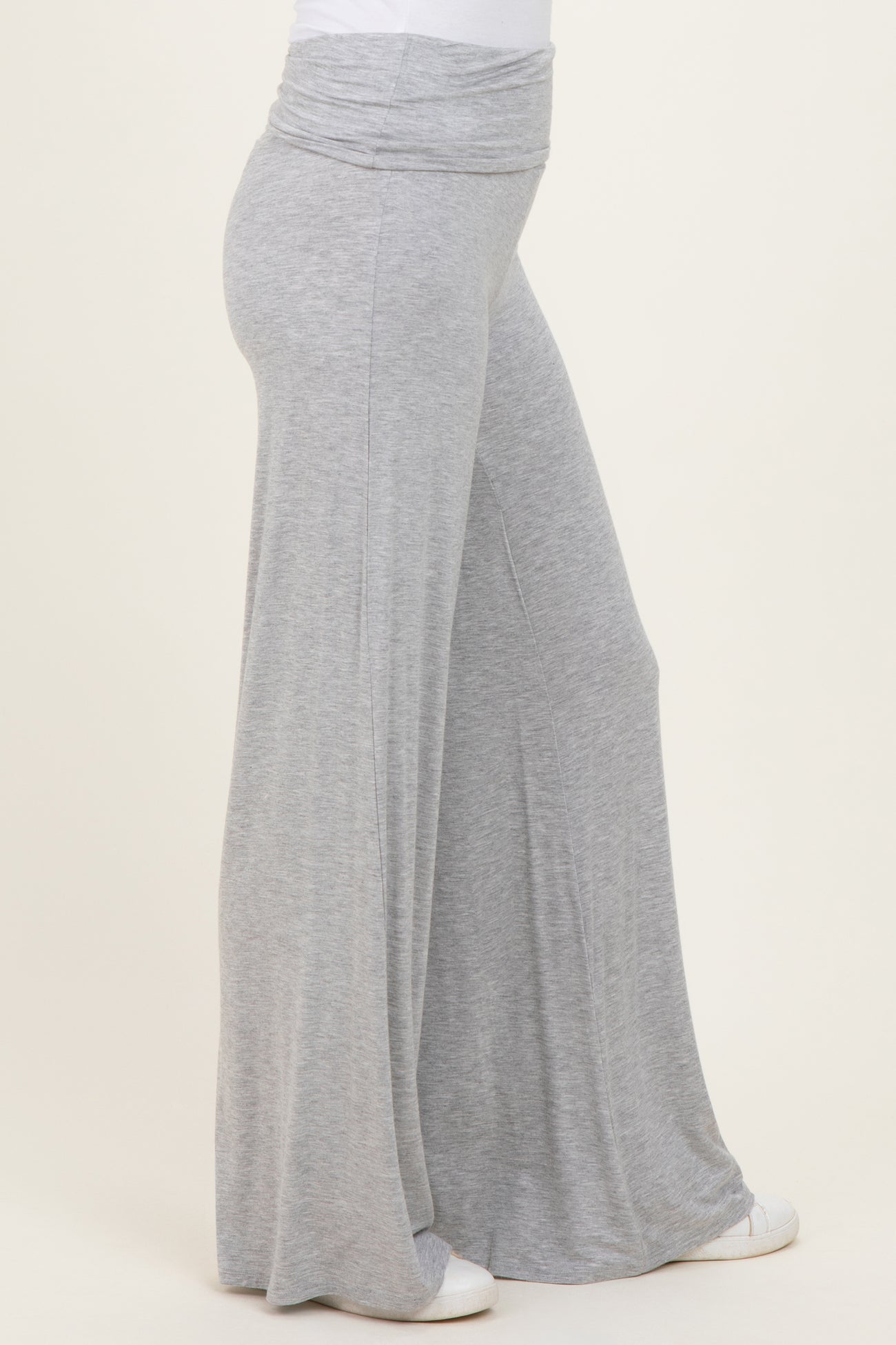 woman wearing light gray wide-leg pants with a fold-over waistband