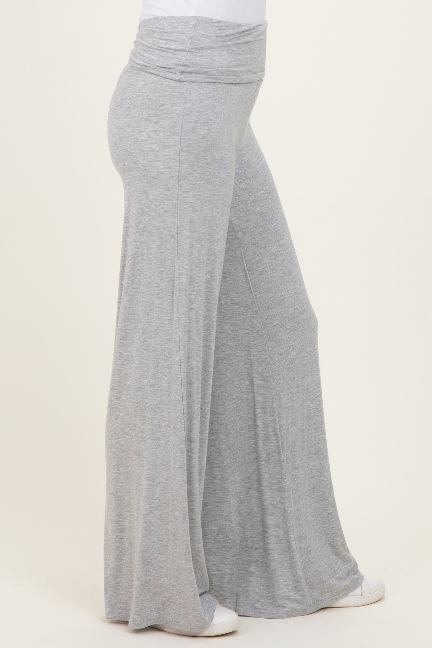 woman wearing light gray wide-leg pants with a fold-over waistband