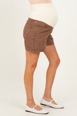 woman wearing brown maternity shorts with a supportive belly band and a visible baby bump