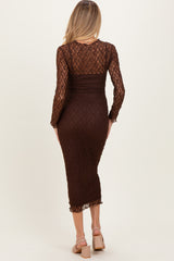 woman wearing a brown lace long sleeve maternity dress, showcasing a fitted silhouette and mid-length cut