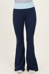 woman wearing navy blue flared yoga pants with a light blue waistband