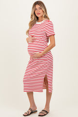 woman wearing a red and white striped maternity dress with side slits and holding her baby bump