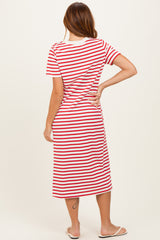 woman wearing a red and white striped midi dress with short sleeves and a relaxed fit, viewed from the back