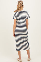 woman wearing a navy and white striped maternity dress with a knee-length cut, view from the back
