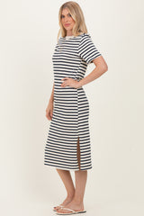 woman wearing a navy and white striped midi dress with short sleeves and side slits