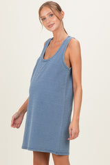 woman wearing a striped maternity tank dress and showing her baby bump
