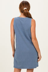 woman wearing a blue and white striped sleeveless dress, seen from the back