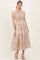woman wearing a floral maxi dress with thin straps and a smocked bodice in pastel colors
