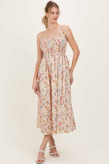 woman wearing a floral print midi dress with spaghetti straps and shirred bodice