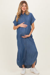 woman wearing a blue denim maxi maternity dress with short sleeves and a baby bump