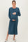 woman wearing a teal long sleeve maternity dress with a side slit and holding her baby bump