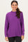 woman wearing a purple long sleeve sweater with a relaxed fit and ribbed hem
