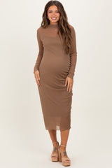 woman wearing a brown long sleeve maternity dress with ruching and a visible baby bump