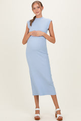 woman wearing a light blue ribbed maternity dress with cap sleeves and a baby bump