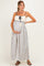 woman wearing a navy and white patterned maternity maxi dress with a crochet bodice and holding her baby bump