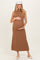 woman wearing a brown sleeveless ribbed maternity dress and holding her baby bump