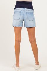 woman wearing light blue maternity denim shorts with a rolled hem and stretchy black waistband, showing no baby bump
