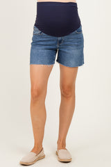 woman wearing maternity denim shorts with a navy blue over-the-bump waistband and frayed hems
