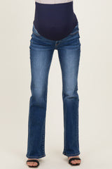 woman wearing dark blue maternity jeans with a stretchy over-the-bump waistband and a flared leg style