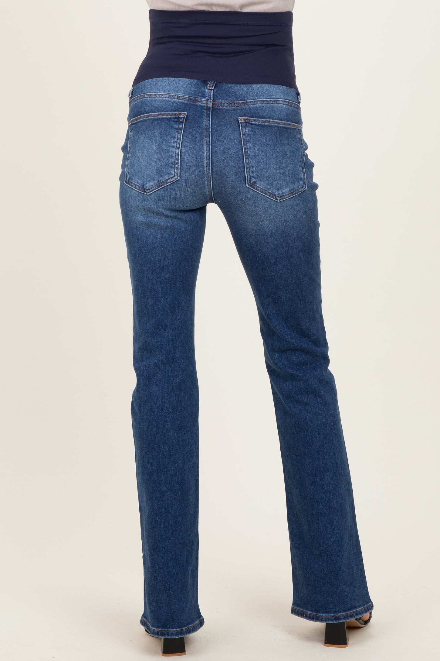maternity wear dark wash bootcut jeans with a stretchy waistband viewed from the back