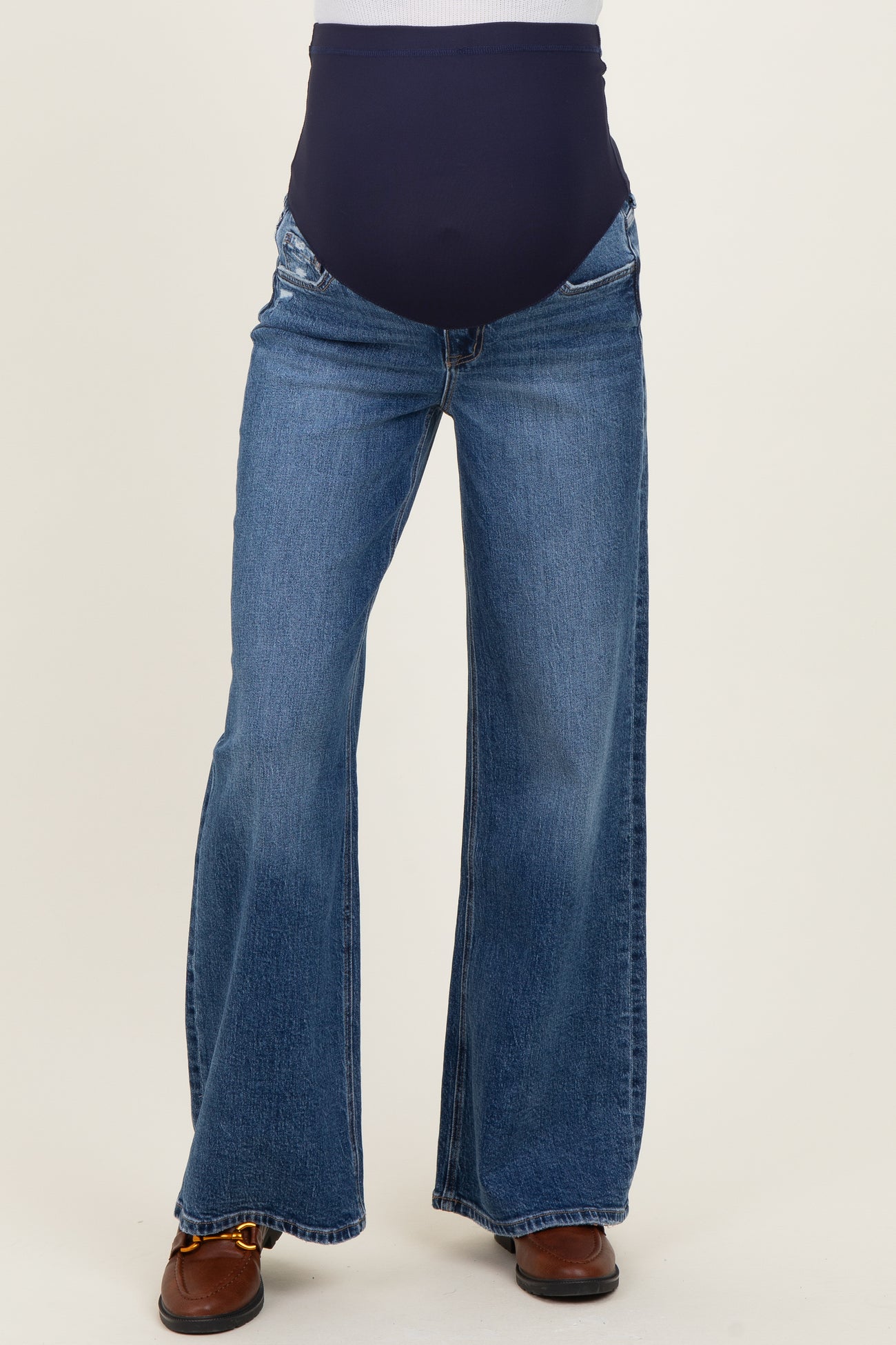 maternity wear flared blue jeans with a wide waistband, designed for comfort during pregnancy