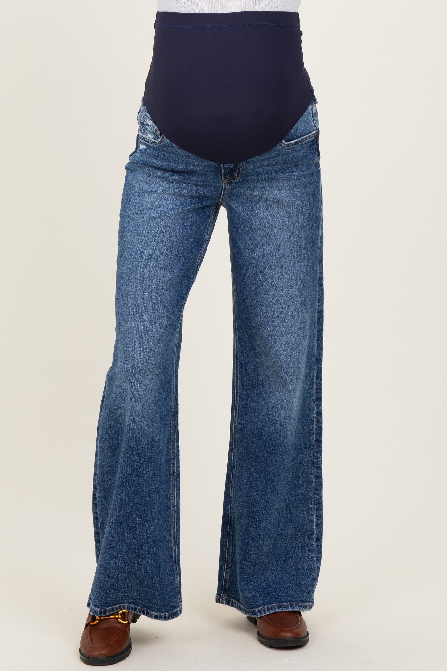maternity wear flared blue jeans with a wide waistband, designed for comfort during pregnancy