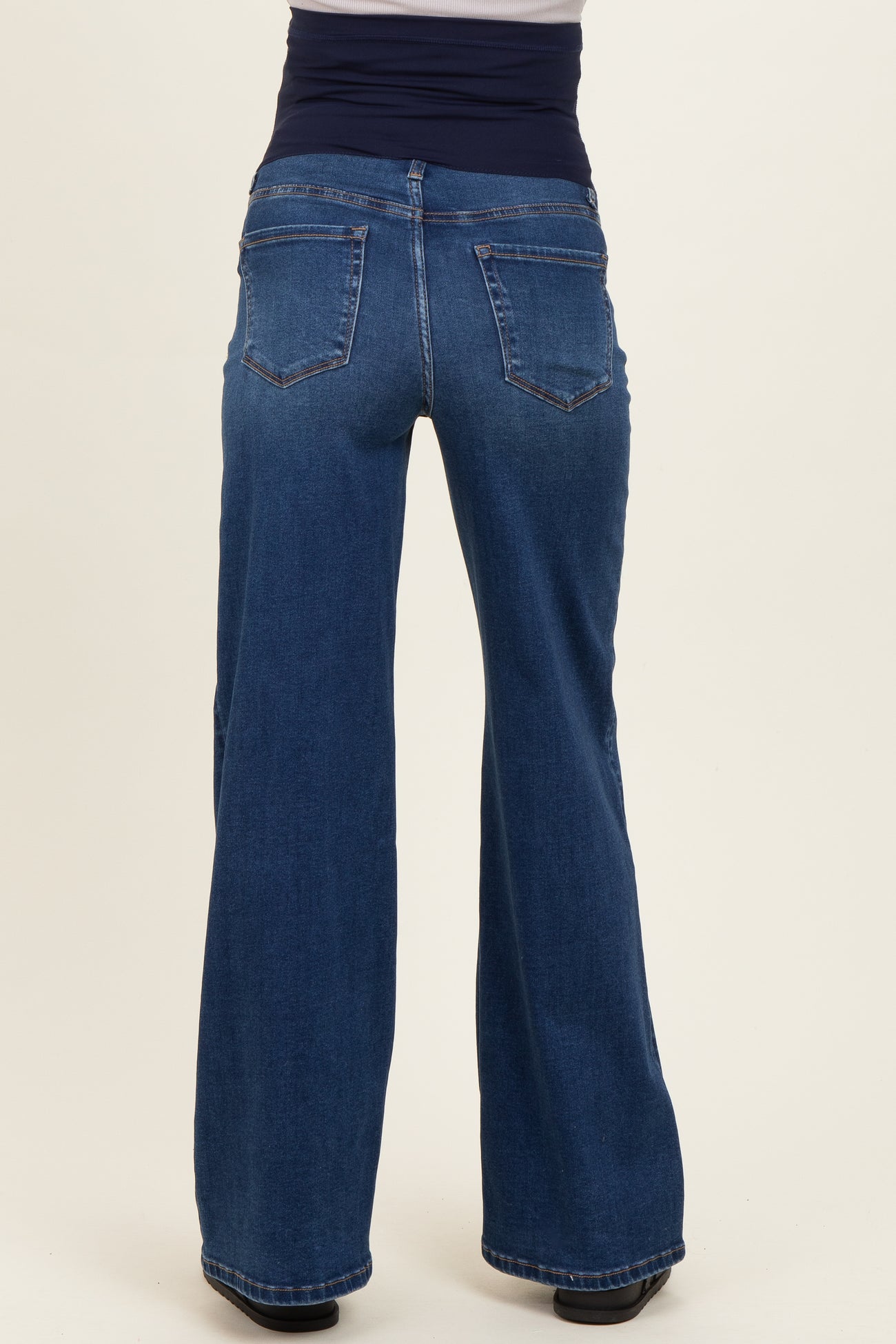 maternity wear dark blue wide leg jeans with a supportive belly band, view from the back