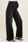 woman wearing black distressed maternity jeans with a high waistband and a visible baby bump