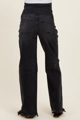 woman wearing black maternity jeans with a frayed hem and a stretchy waistband, viewed from the back