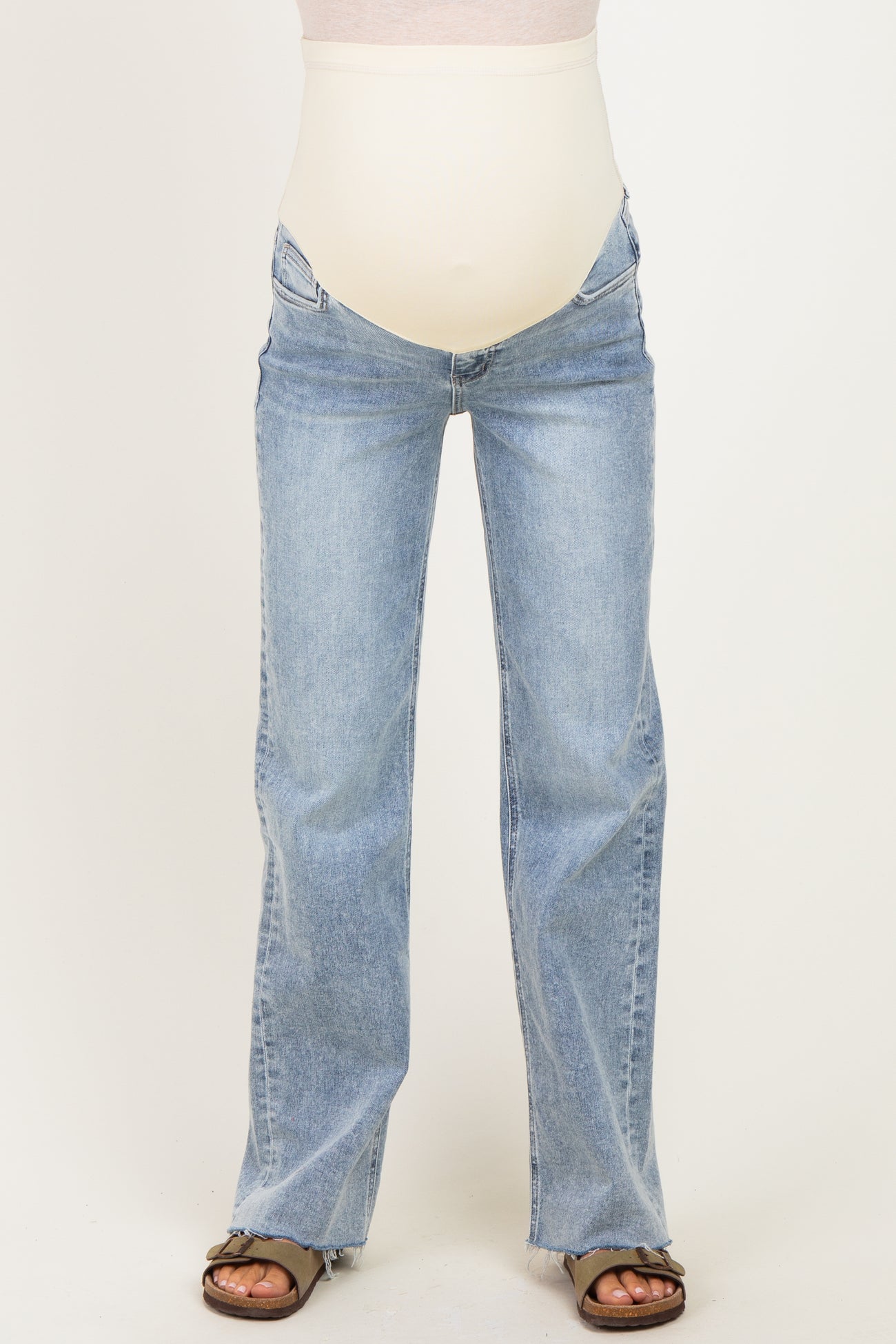 woman wearing light blue maternity flare jeans with a support panel for a baby bump