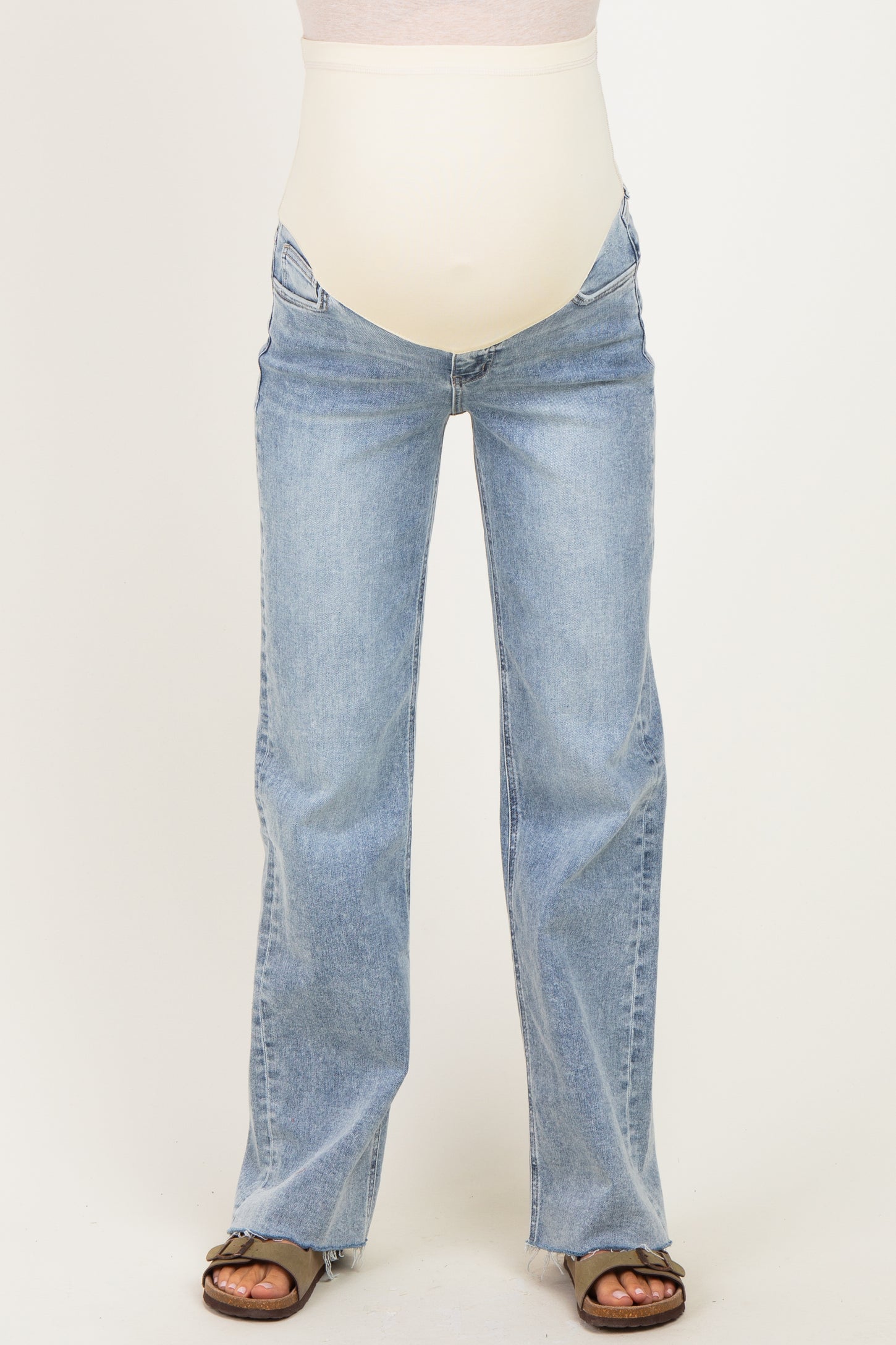 woman wearing light blue maternity flare jeans with a support panel for a baby bump