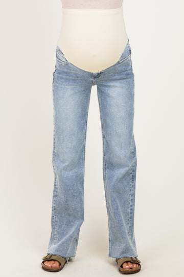 woman wearing light blue maternity flare jeans with a support panel for a baby bump