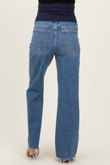 woman wearing a pair of light wash maternity jeans with a stretchy waistband, shown from the back
