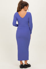 woman wearing a purple ribbed maternity dress with a v-back and long sleeves