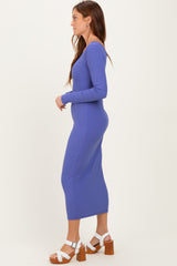 woman wearing a purple ribbed long sleeve midi dress and white heeled sandals