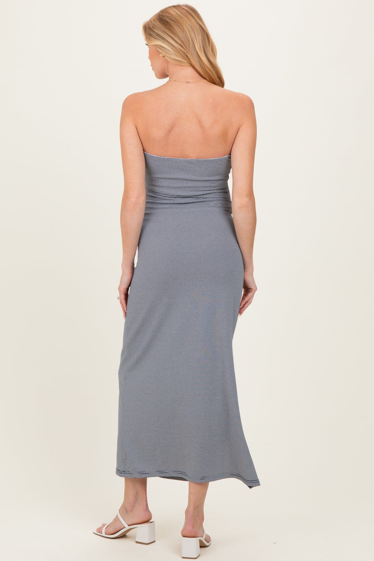 woman wearing a gray striped strapless maternity maxi dress, showing a smooth fit and flowing silhouette