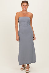 woman wearing a strapless gray striped maxi dress with a fitted bodice and relaxed skirt