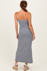 woman wearing a gray strapless maxi dress with a fitted silhouette and ruched details, viewed from the back