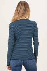 woman wearing a navy blue and teal striped long sleeve maternity top with a fitted style